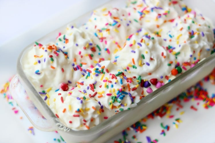 Cake batter ice cream is absolutely delicious and this no churn variety comes together in just minutes. Loaded with sprinkles it is the perfect ice cream for any celebration!