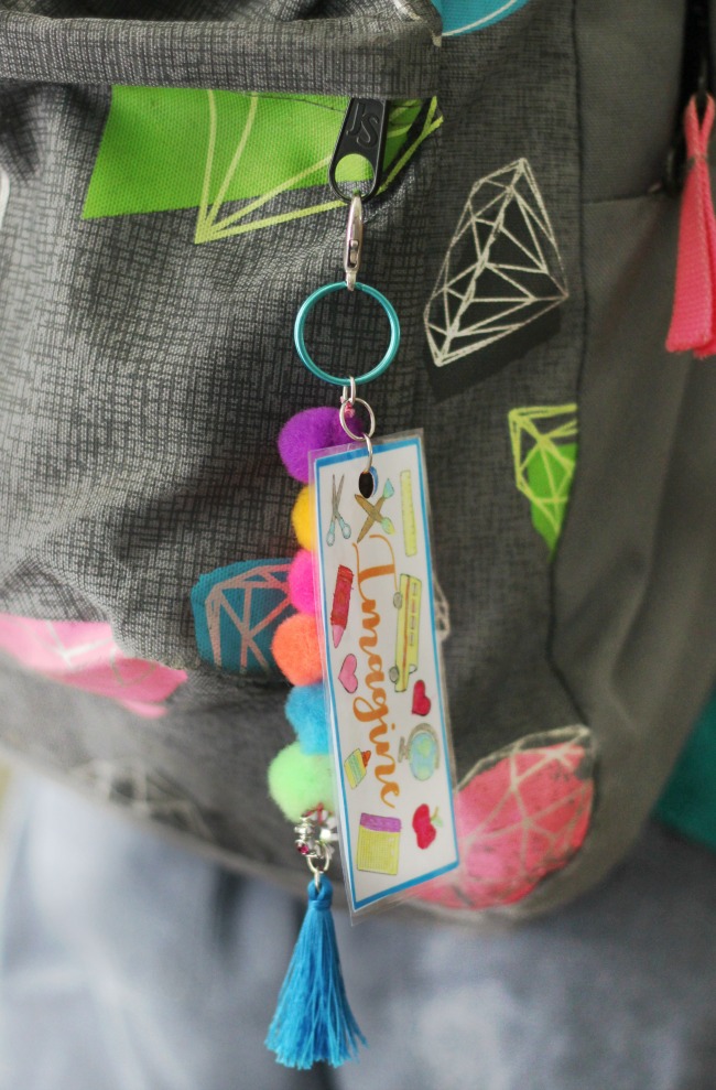 Make a pom pom key chain to accessorize your back pack this year! With a printable name tag to color, it is a fun and personalized way to label your bag!