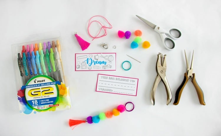 Make a pom pom key chain to accessorize your back pack this year! With a printable name tag to color, it is a fun and personalized way to label your bag!