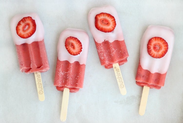 These real strawberry fruit bars are dipped in low-fat strawberry banana yogurt and topped with a fresh strawberry slice. It's like a smoothie on a stick!