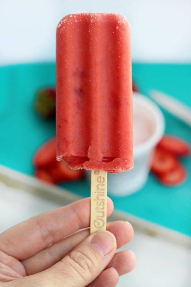 These real strawberry fruit bars are dipped in low-fat strawberry banana yogurt and topped with a fresh strawberry slice. It's like a smoothie on a stick!