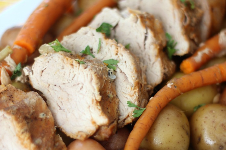 slices of pork tenderloin with potatoes and carrots