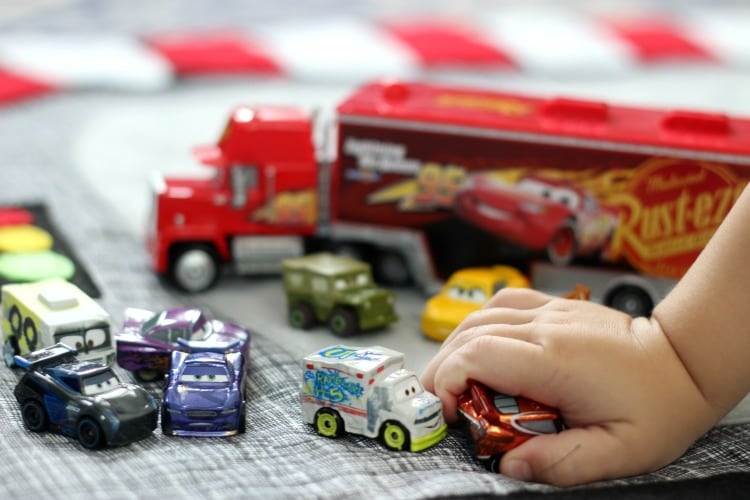 Make a race track play mat to inspire creative play in your home! This double sided mat is soft to sit on and folds up for easy storage. The perfect place to play with your favorite cars and trucks!