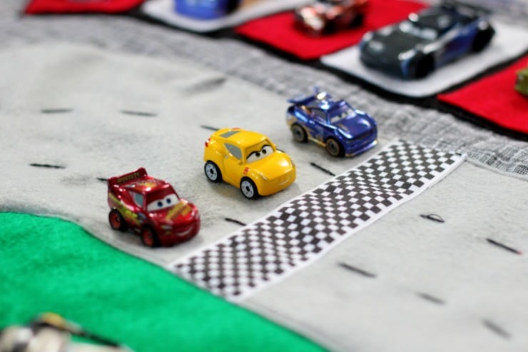 Make a race track play mat to inspire creative play in your home! This double sided mat is soft to sit on and folds up for easy storage. The perfect place to play with your favorite cars and trucks!