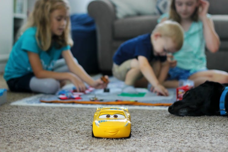 Make a race track play mat to inspire creative play in your home! This double sided mat is soft to sit on and folds up for easy storage. The perfect place to play with your favorite cars and trucks!