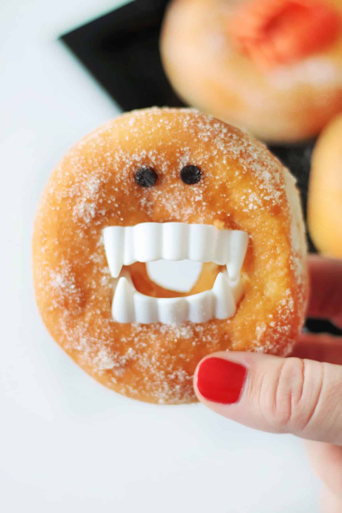 Hand holding vampire donut.