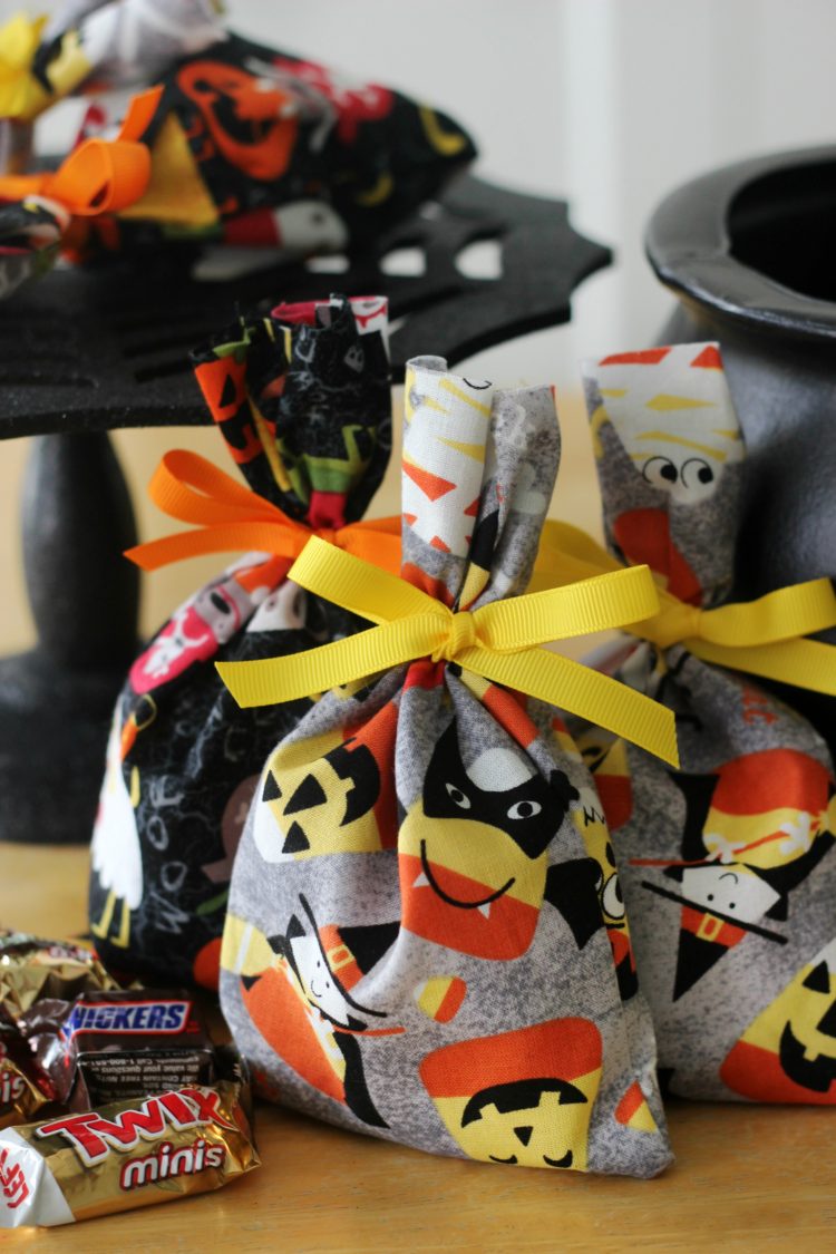 These treat bags are easy to make and fun to fill with candy. Use them as mini BOO kits and doorbell ditch on Halloween! A 2-minute sewing tutorial!