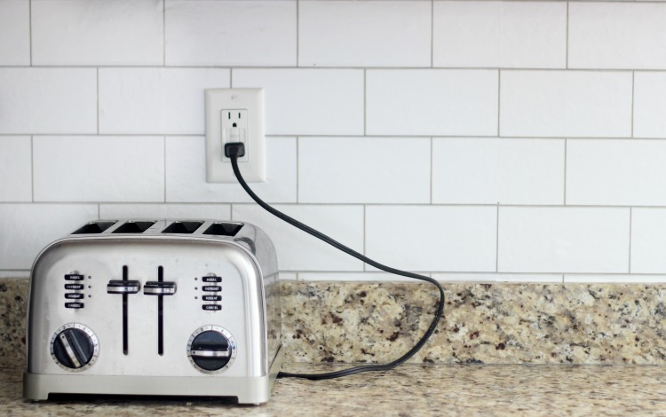 Transform your kitchen with a $35 subway tile backsplash using wallpaper! This peel and stick wallpaper is inexpensive and easy to work with! 