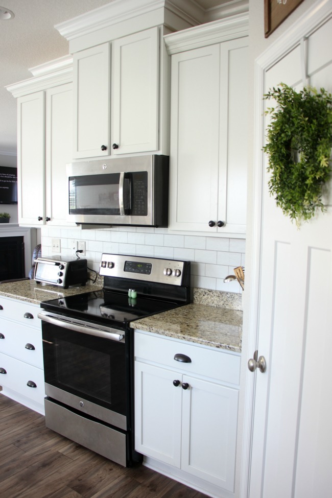 Transform your kitchen with a $35 subway tile backsplash using wallpaper! This peel and stick wallpaper is inexpensive and easy to work with! 