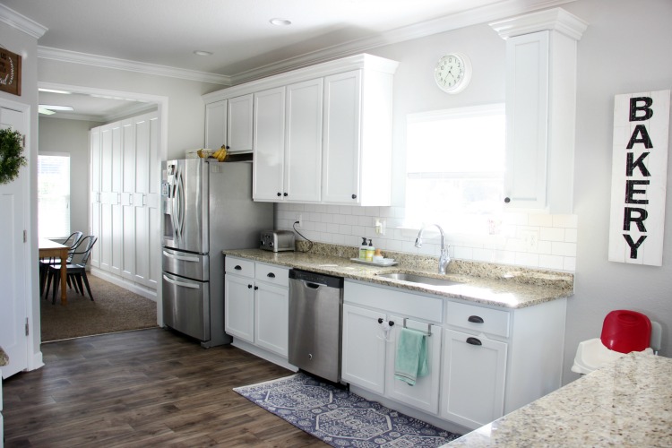 Transform your kitchen with a $35 subway tile backsplash using wallpaper! This peel and stick wallpaper is inexpensive and easy to work with! 