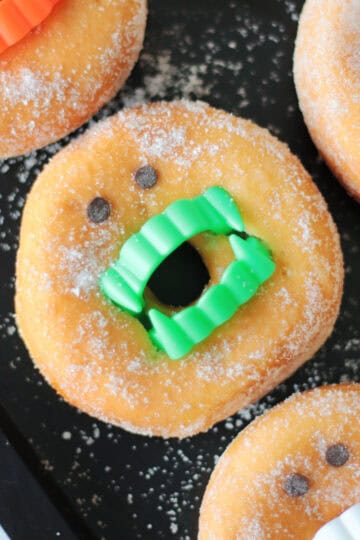 Vampire donut with green fangs.