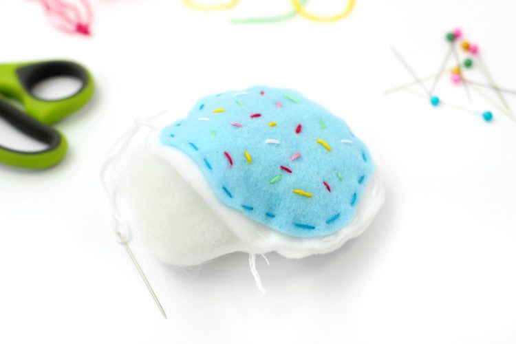 Now that you’re learning to sew, you’ll need a place to keep all of your pins. Here is a simple DIY felt pincushion shaped like a sugar cookie! Complete with your favorite flavor of frosting and colorful sprinkles! 