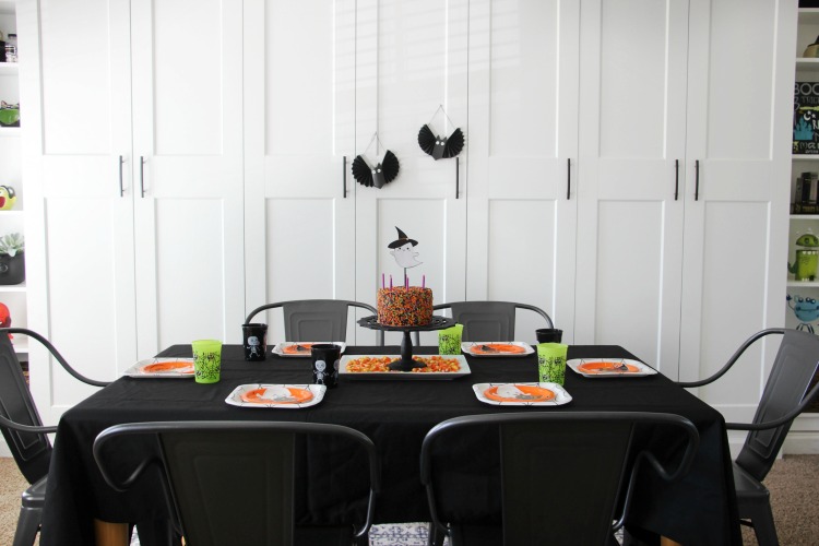 table set up with plates and halloween cake