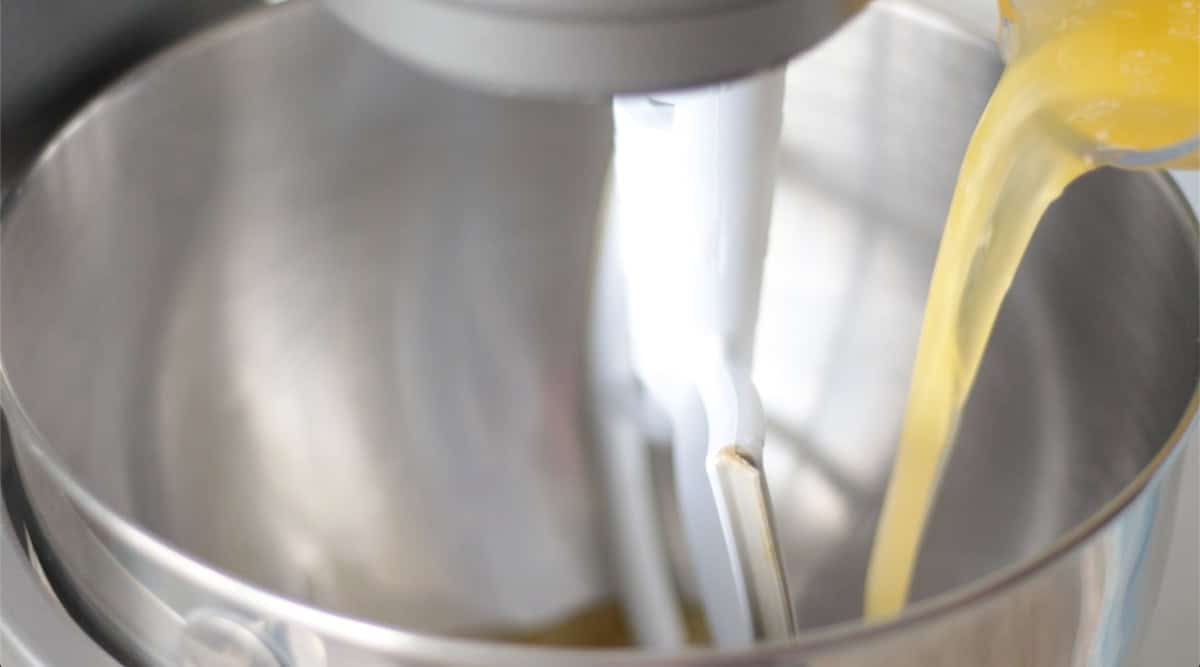 Melted butter poured into metal mixing bowl.