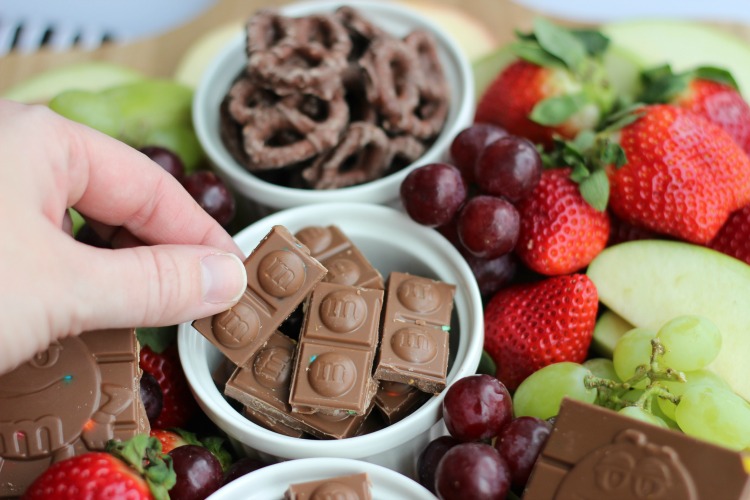 A simple and sweet chocolate dessert board with fruit! Perfect for a gathering! Strawberries, grapes, apples and two types of chocolate.