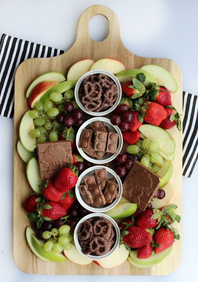 A simple and sweet chocolate dessert board with fruit! Perfect for a gathering! Strawberries, grapes, apples and two types of chocolate.