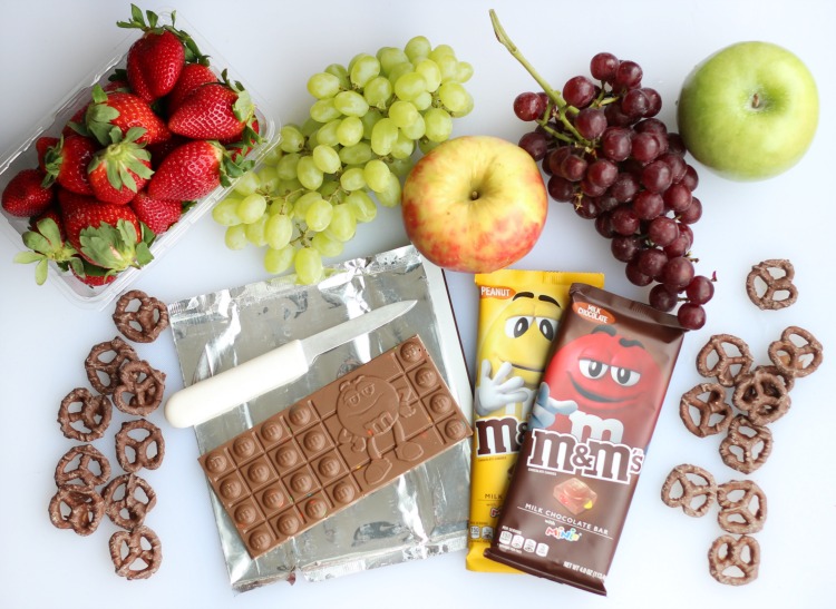 A simple and sweet chocolate dessert board with fruit! Perfect for a gathering! Strawberries, grapes, apples and two types of chocolate.