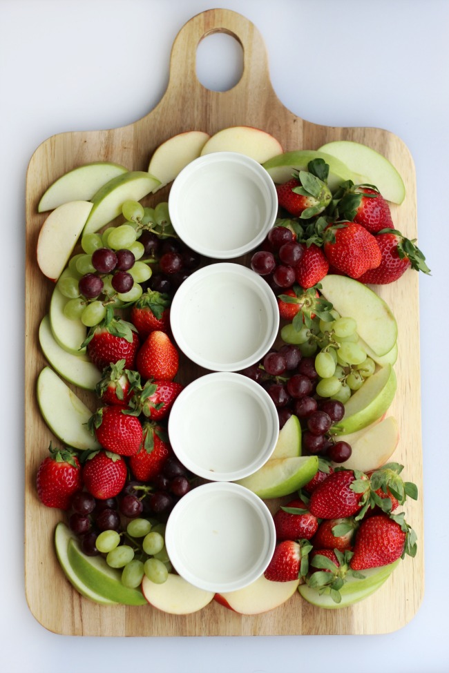 A simple and sweet chocolate dessert board with fruit! Perfect for a gathering! Strawberries, grapes, apples and two types of chocolate.