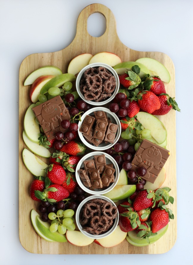 A simple and sweet chocolate dessert board with fruit! Perfect for a gathering! Strawberries, grapes, apples and two types of chocolate.