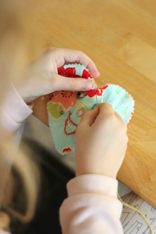 These DIY heart plushies come together quickly, and are a great beginning sewing project for kids! Fill with stuffing, dried lavender or beans!