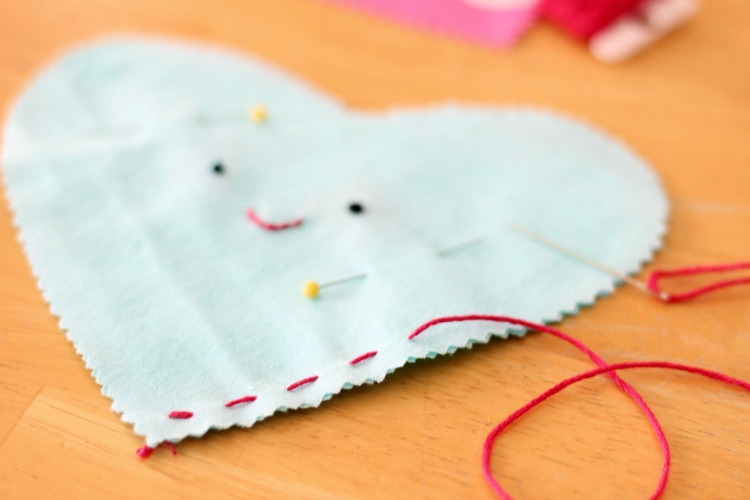 These DIY heart plushies come together quickly, and are a great beginning sewing project for kids! Fill with stuffing, dried lavender or beans!