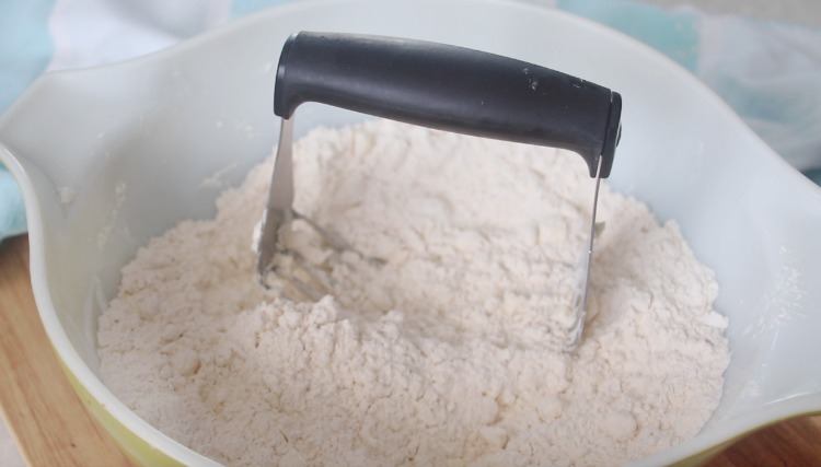 pastry cutter in bowl of flour and butter