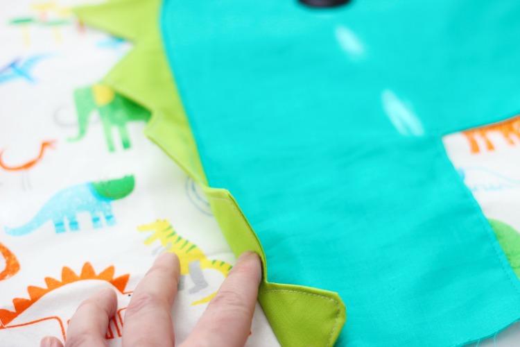 A free dinosaur pillowcase pattern available in travel, kid, or standard size! So cute and easy to customize. A great beginner sewing project.