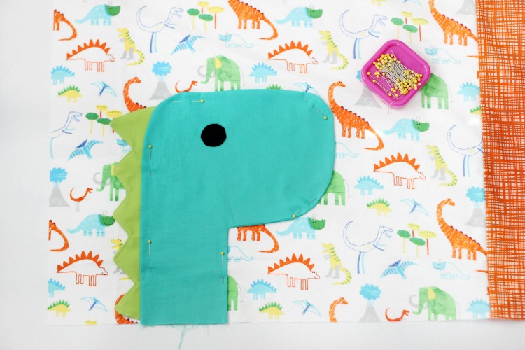 A free dinosaur pillowcase pattern available in travel, kid, or standard size! So cute and easy to customize. A great beginner sewing project.