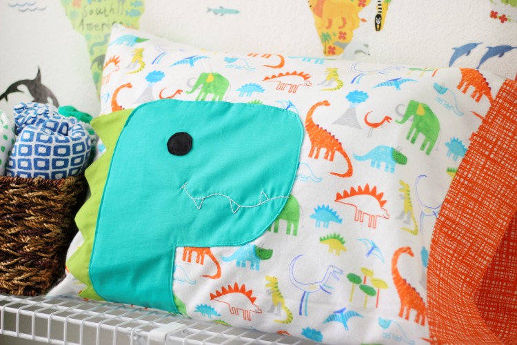 A free dinosaur pillowcase pattern available in travel, kid, or standard size! So cute and easy to customize. A great beginner sewing project.