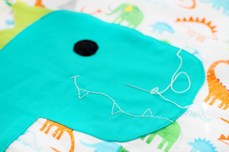 A free dinosaur pillowcase pattern available in travel, kid, or standard size! So cute and easy to customize. A great beginner sewing project.