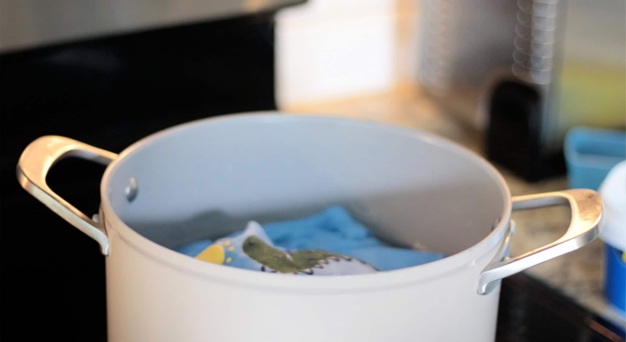 Pot of hot water with baby oneside soaking inside.