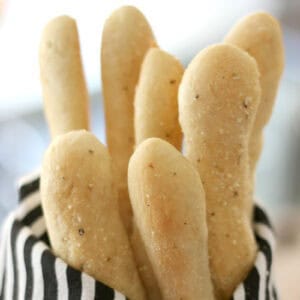 Garlic breadsticks wrapped in hand towel.
