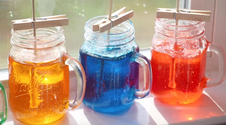 jars of rock candy syrup in window