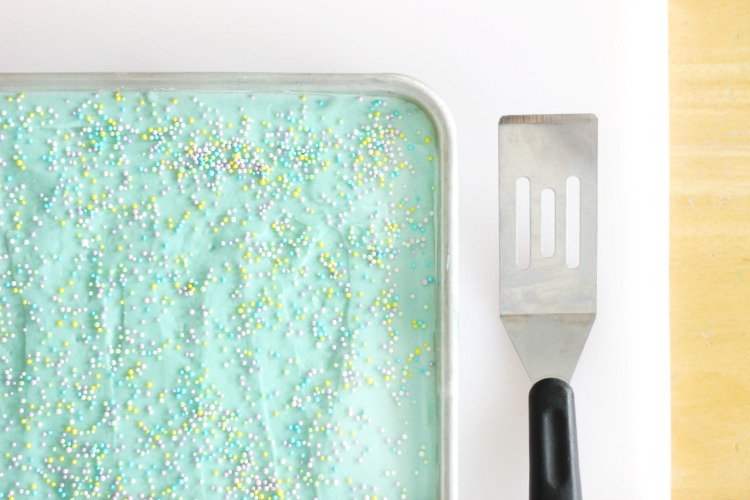 tray of sugar cookie bars with small spatula