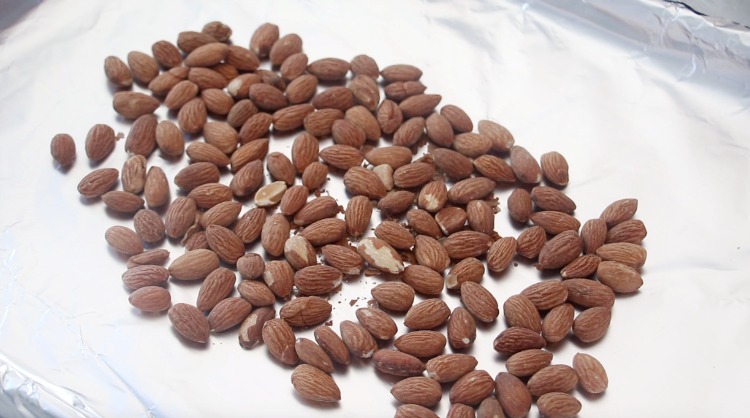 whole almonds on baking sheet lined in foil
