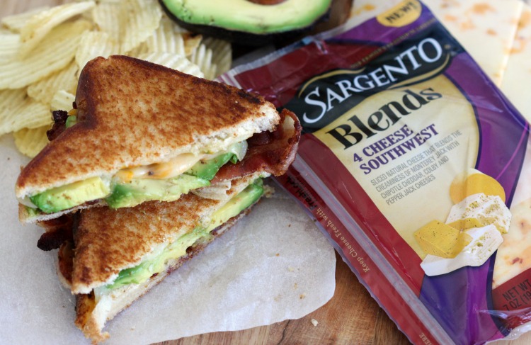 finished avocado bacon grilled cheese sandwich next to package of cheese