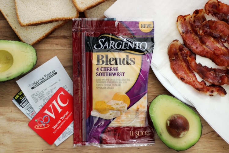 sargento cheese, avocado, bacon slices and bread slices on cutting board