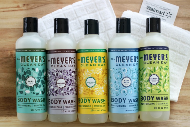 bottles of mrs meyers body wash lined up on table