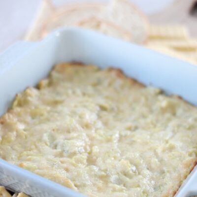 blue dish with hot artichoke dip