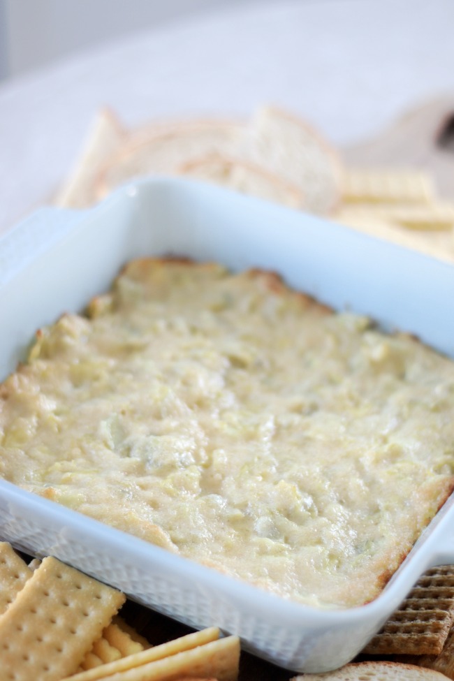 blue dish with hot artichoke dip