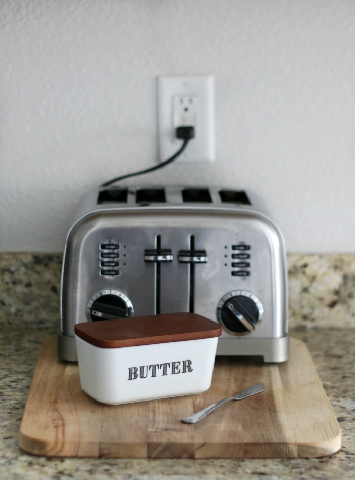 countertop styling with toaster on cutting board and butter dish