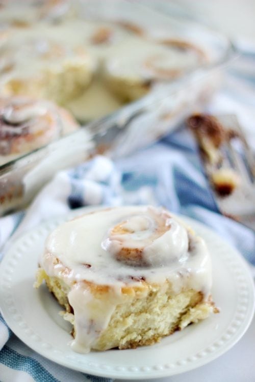 Cinnamon roll on white plate.