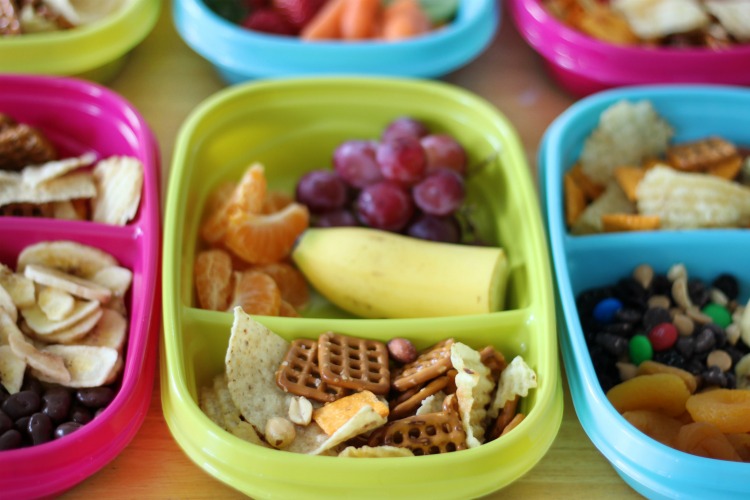 snack containers sectioned off with fruit and snack mix