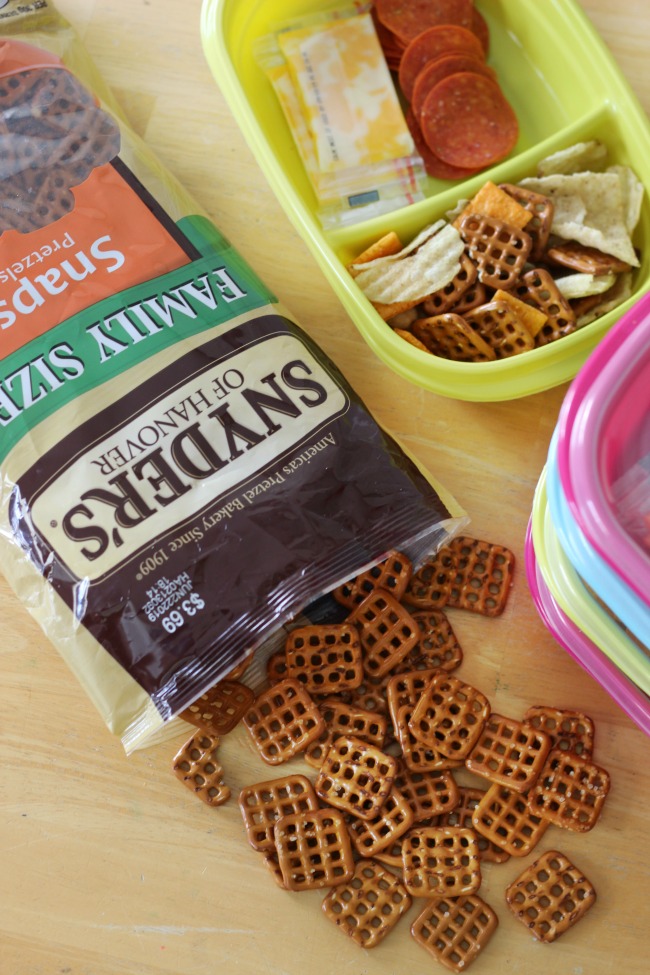 pretzels on table with container filled with road trip snacks