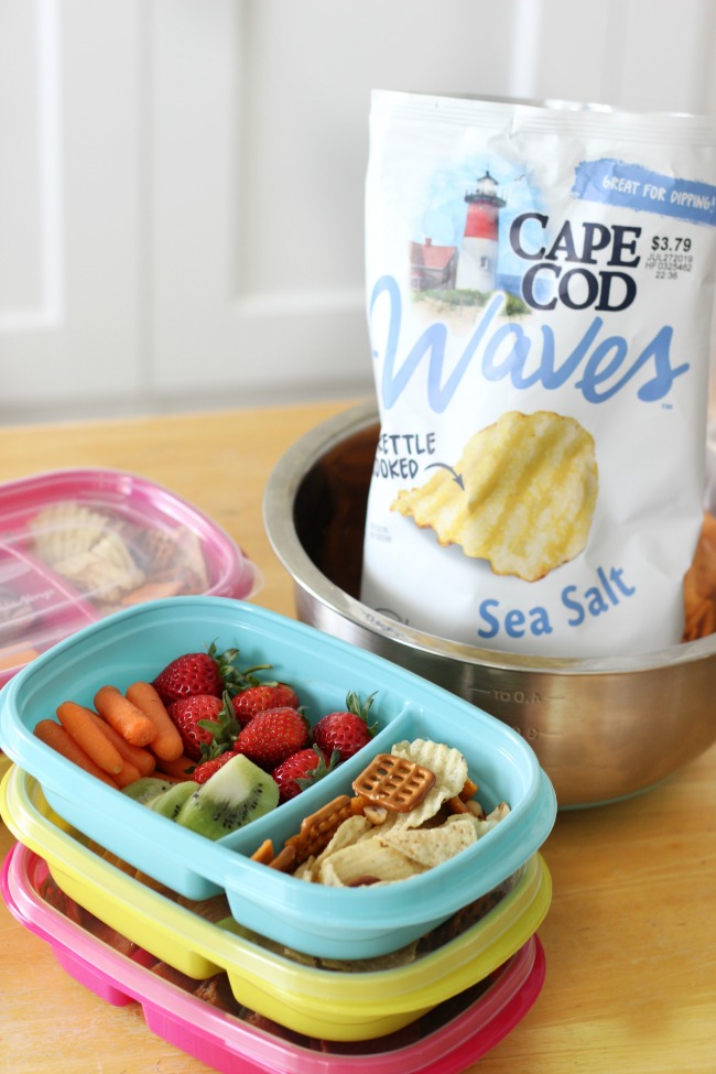 snack tray filled with carrots strawberries kiwi and chips