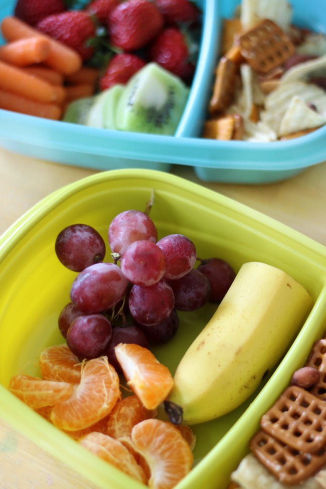 fresh fruit road trip snacks grapes, bananas, oranges and snack mix