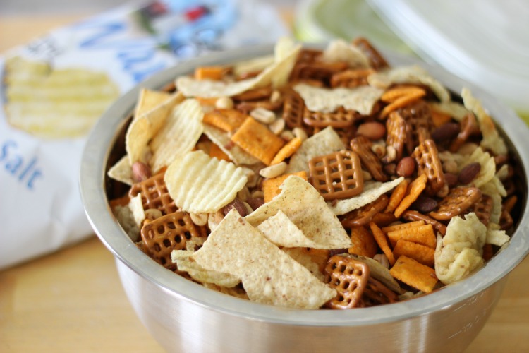 bowl filled with tortilla chips, potato chips, pretzels and cheese crackers