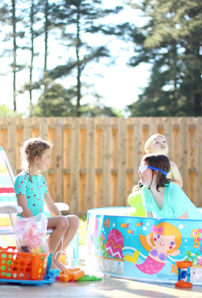 backyard activities for kids: kids sitting poolside