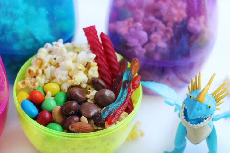popcorn and candy in a snack cup with dragon toy