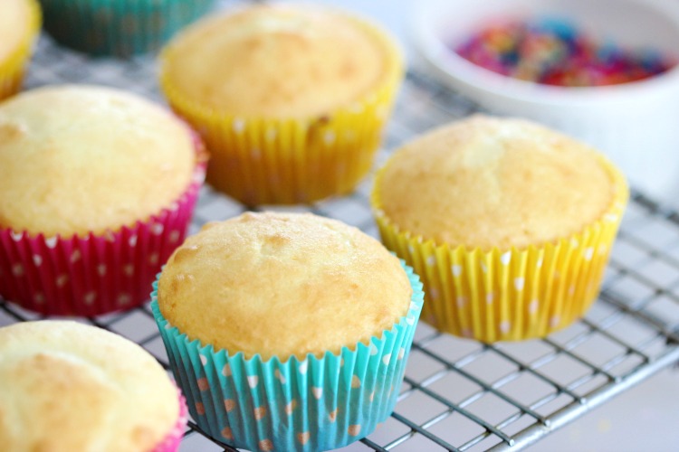 white cupcakes on cooling rack